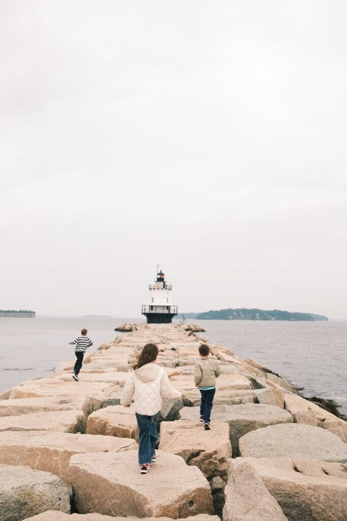 spring point ledge lighthouse with kids running on the jetty towards the lighthouse